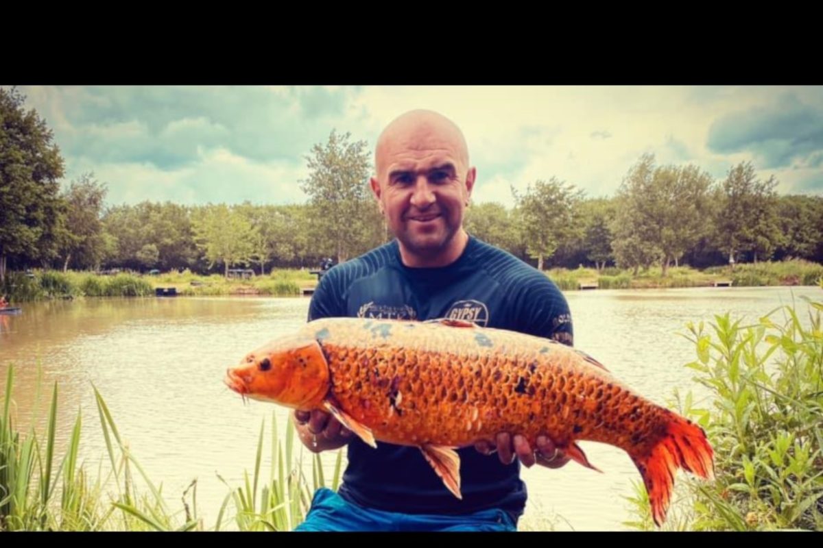 Craig Kent an einem Teich der Woodland Lakes Fisheries mit einem Ghostkarpfen.