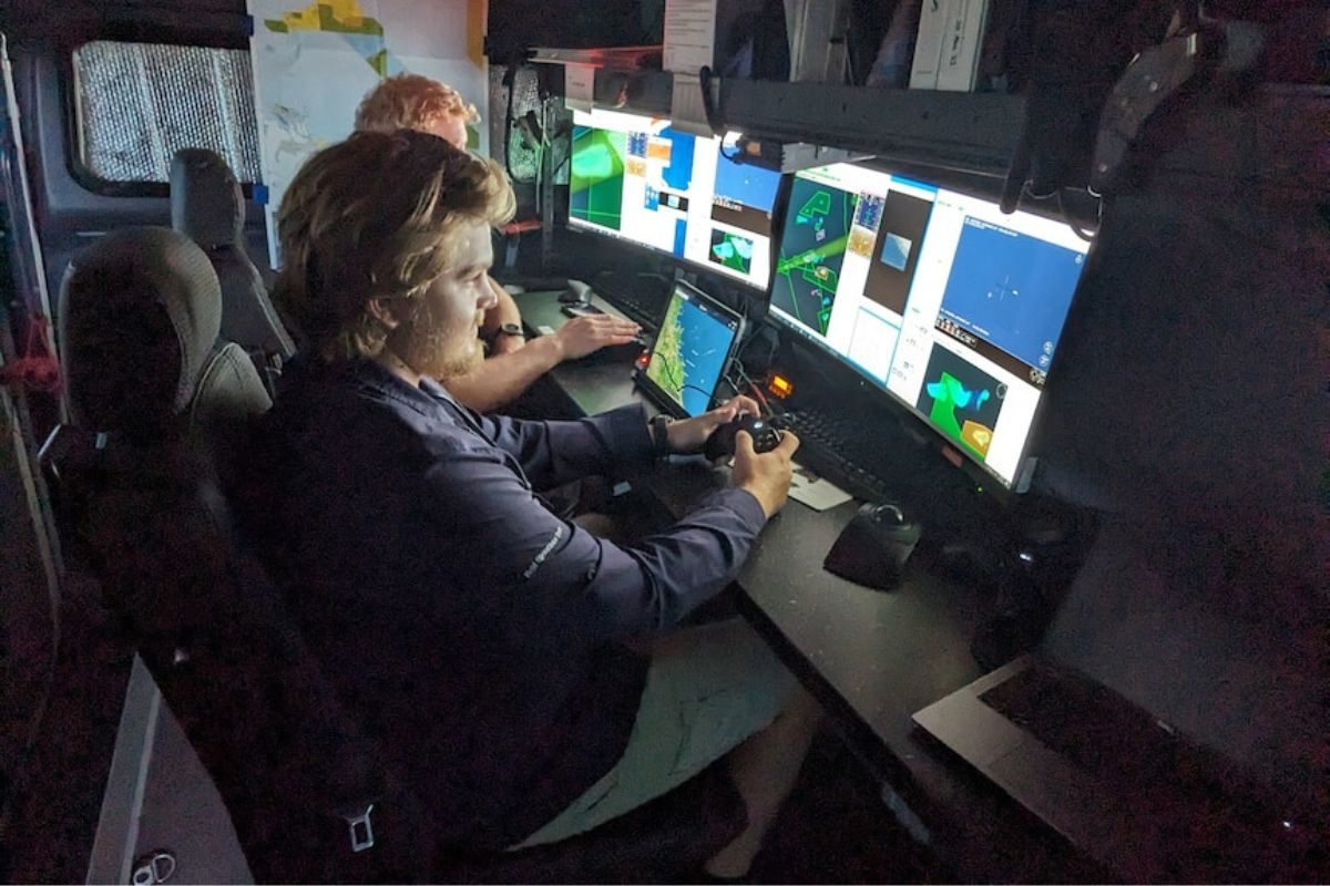 Fischereiaufseher hinter Bildschirm steuert Drohne
