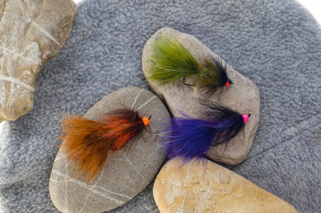 Drei Woolly Bugger-Fliegen in grün, blau und braun