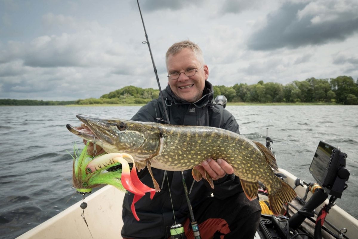 Angler mit Hecht auf Boot