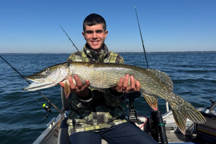 Angler mit Hecht auf Boot